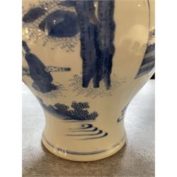 Pair of Chinese Kangxi blue and white porcelain vases, each of baluster form, painted with an outdoor scene containing figures seated upon the ground reading scrolls and holding fans, willow and bamboo tress, rock work and water, H27cm