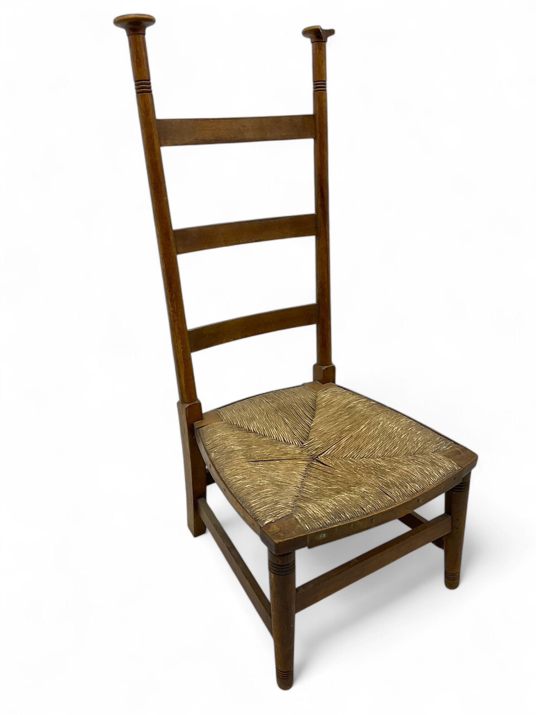 Attributed to William Birch of High Wycombe - Arts & Crafts oak ladder-back side chair, with turned finials, rush seat, and stretchers, raised on square-section supports; 19th century mahogany Pembroke table, rectangular drop-leaf top raised on turned supports with central stretcher and splayed feet