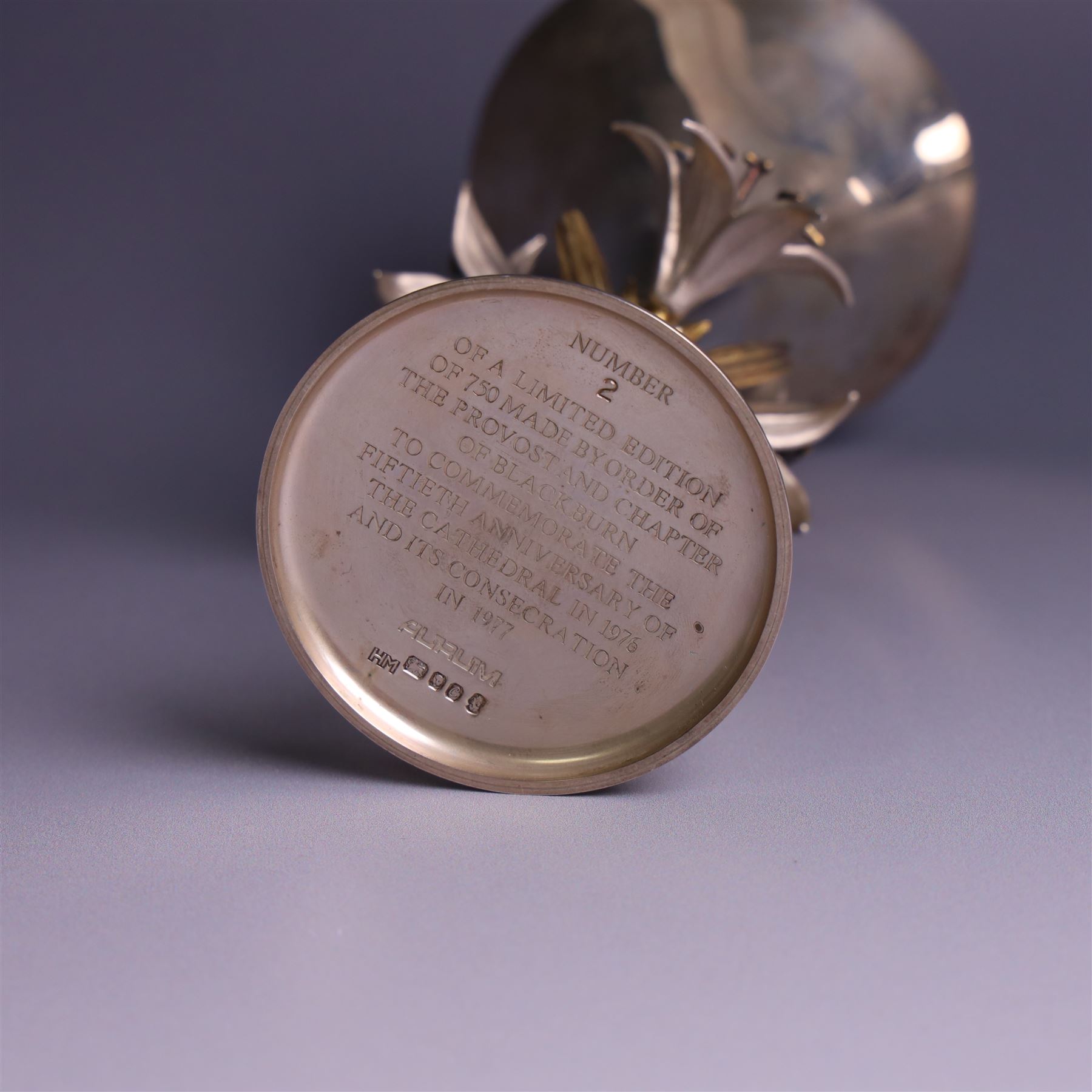 Modern limited edition silver goblet, 'made by order the provost and charter of Blackburn to commemorate the fiftieth anniversary of the cathedral in 1976 and its consecration in 1977' designed by Hector Miller for Aurum, the plain fluted cup, upon a stem of three lillies with parcel gilt highlihts and upon a circular foot, no. 2/750, hallmarked Hector Miller, London 1977, H17cm, boxed with certificate of authenticity