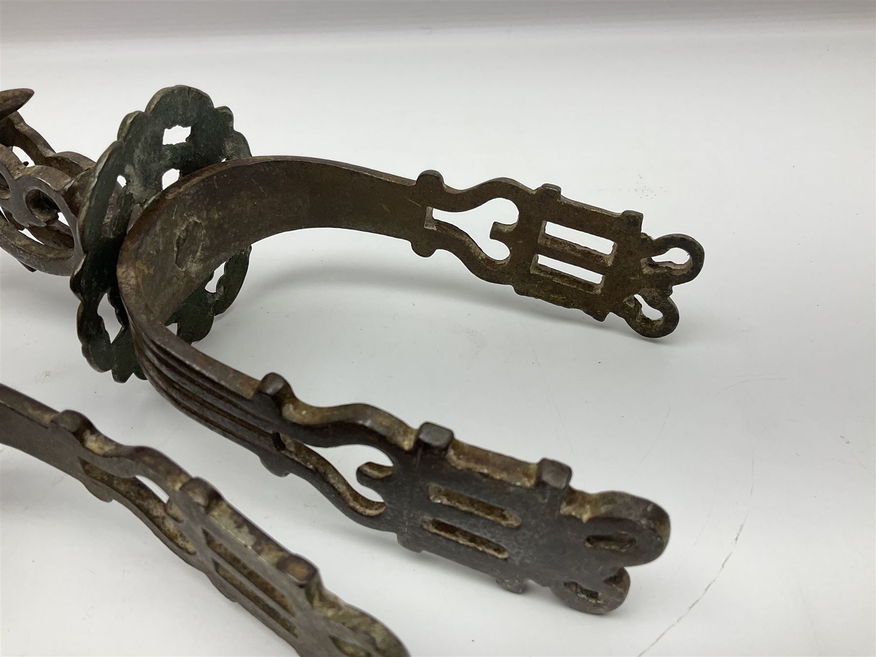 Pair of South American gaucho steel and brass spurs with eight-spike heel rowels, possibly Chilean L25cm