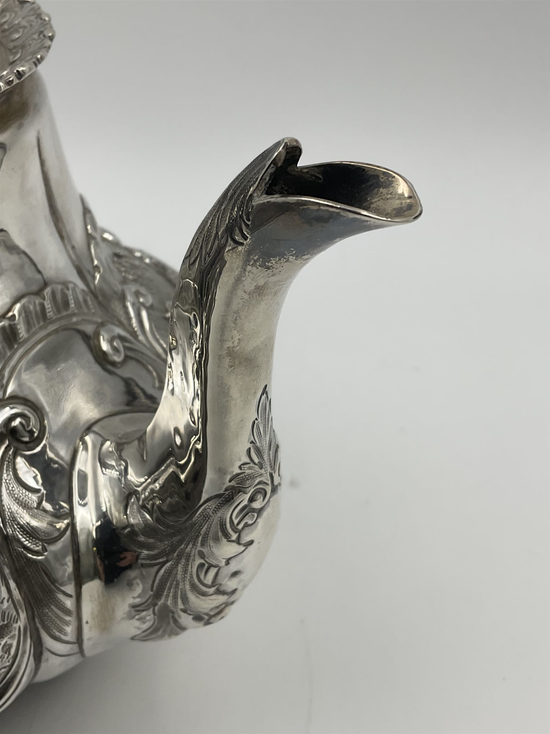 Victorian silver three piece tea service, comprising teapot, twin handled open sucrier, and milk jug, each of bellied form with acanthus capped scroll handles, the sides embossed with alternating scroll edged vacant panels and panels containing a pair of birds, upon four palmette feet, the teapot with ivory insulators to handle, and bird finial to the hinged domed cover, hallmarked William Hunter & Son, London 1861, teapot H19cm, including handles sucrier H13.5cm, including handle milk jug H12cm

This item has been registered for sale under Section 10 of the APHA Ivory Act