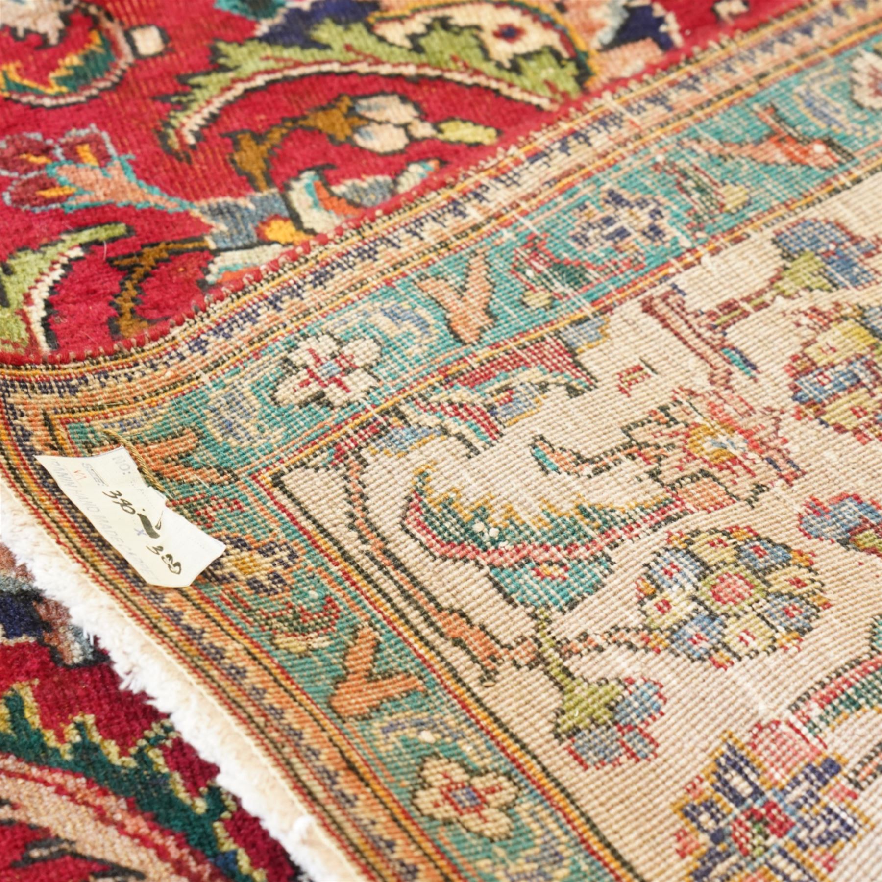 Persian Kashan carpet, red madder field, all over design of scrolling palmettes and flowering vines framed by an ivory border of lotus and arabesques between turquoise and red floral guards 294x387cm