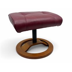 Contemporary burgundy leather reclining armchair and footstool, featuring segmented upholstered cushions and padded armrests, each piece mounted on a circular laminated wood base