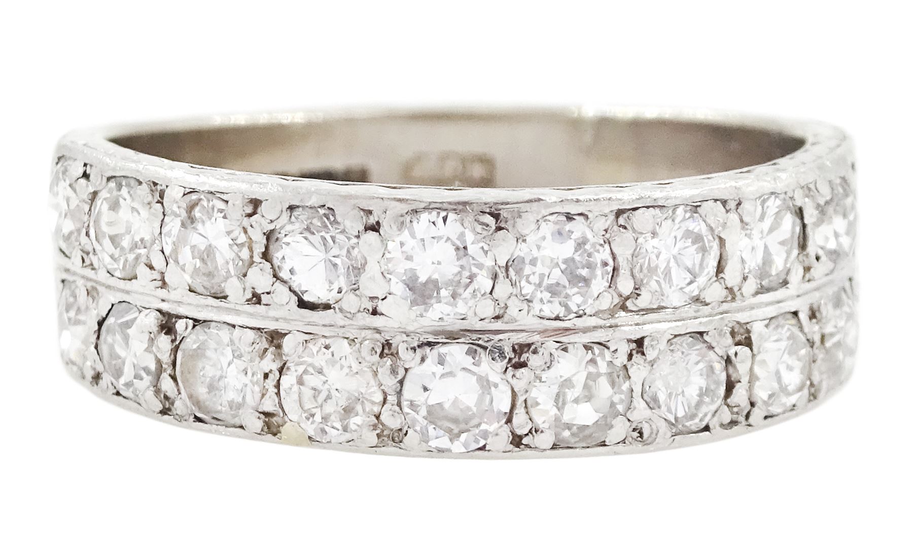 18ct white gold and platinum diamond half eternity ring, two rows each set with ten old cut diamonds, the sides with engraved decoration, Birmingham 1985, total diamond weight approx 1.20 carat