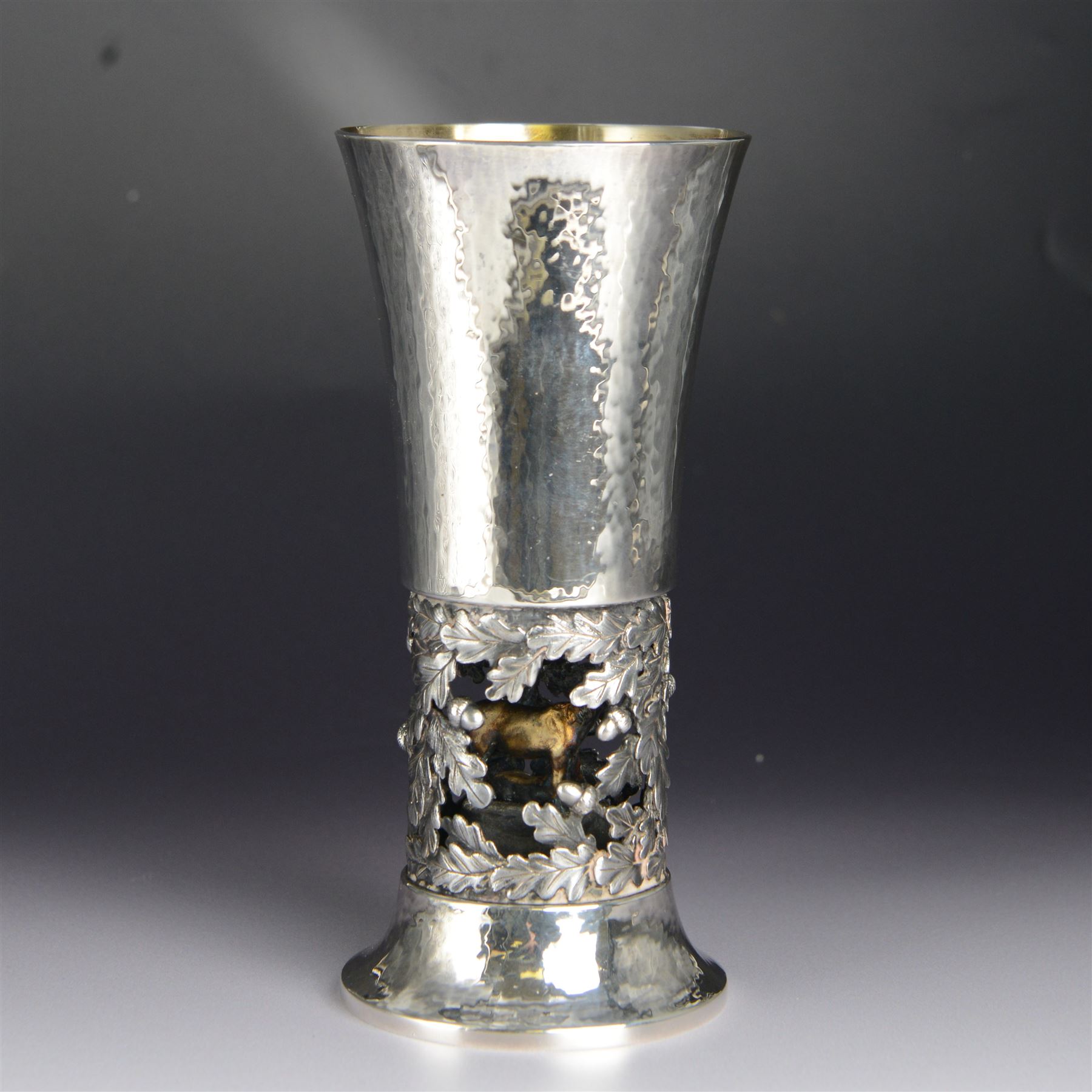 Modern limited edition silver goblet, 'by order of The New Forest of Ninth Centenary Trust this goblet has been produced to mark the 900th anniversary of the Forest in 1979' designed by Hector Miller for Aurum, the fluted planished bowl with gilt interior, upon a stem decorated in relief with oak leaves and acorns revealing a harse and foal to centre, limited edition no. 375, hallmarked Hector Miller, London 1980, H16.5cm, boxed