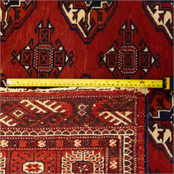 Three rugs,  comprising a Baluch rug in crimson ground, 179x97cm, a Tekke Bokhara rug in crimson ground, 201x132cm, and a Bokhara rug in ochre ground, 125x175cm 