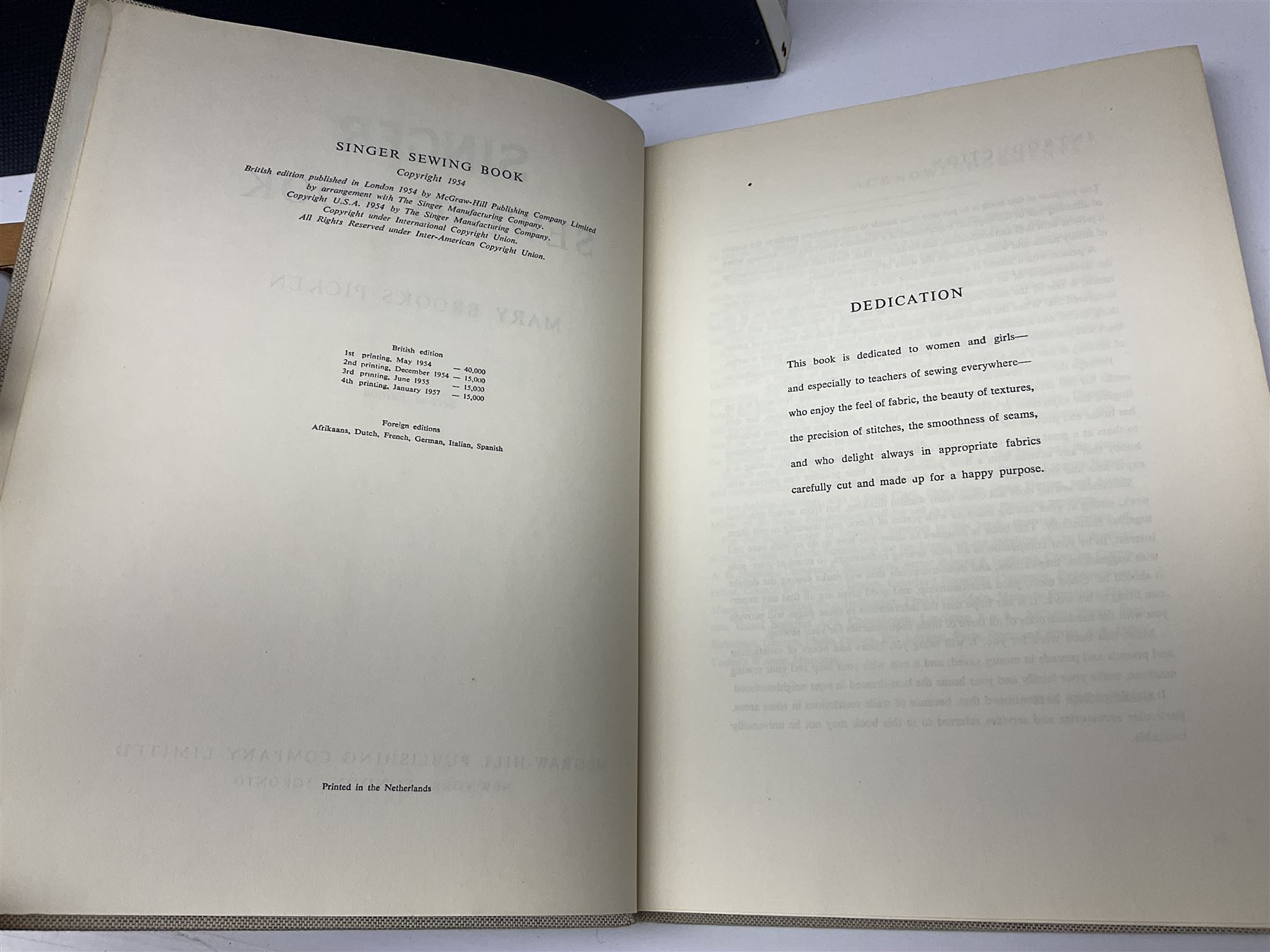 Seamstress sewing machine in case, together with a Singer sewing book