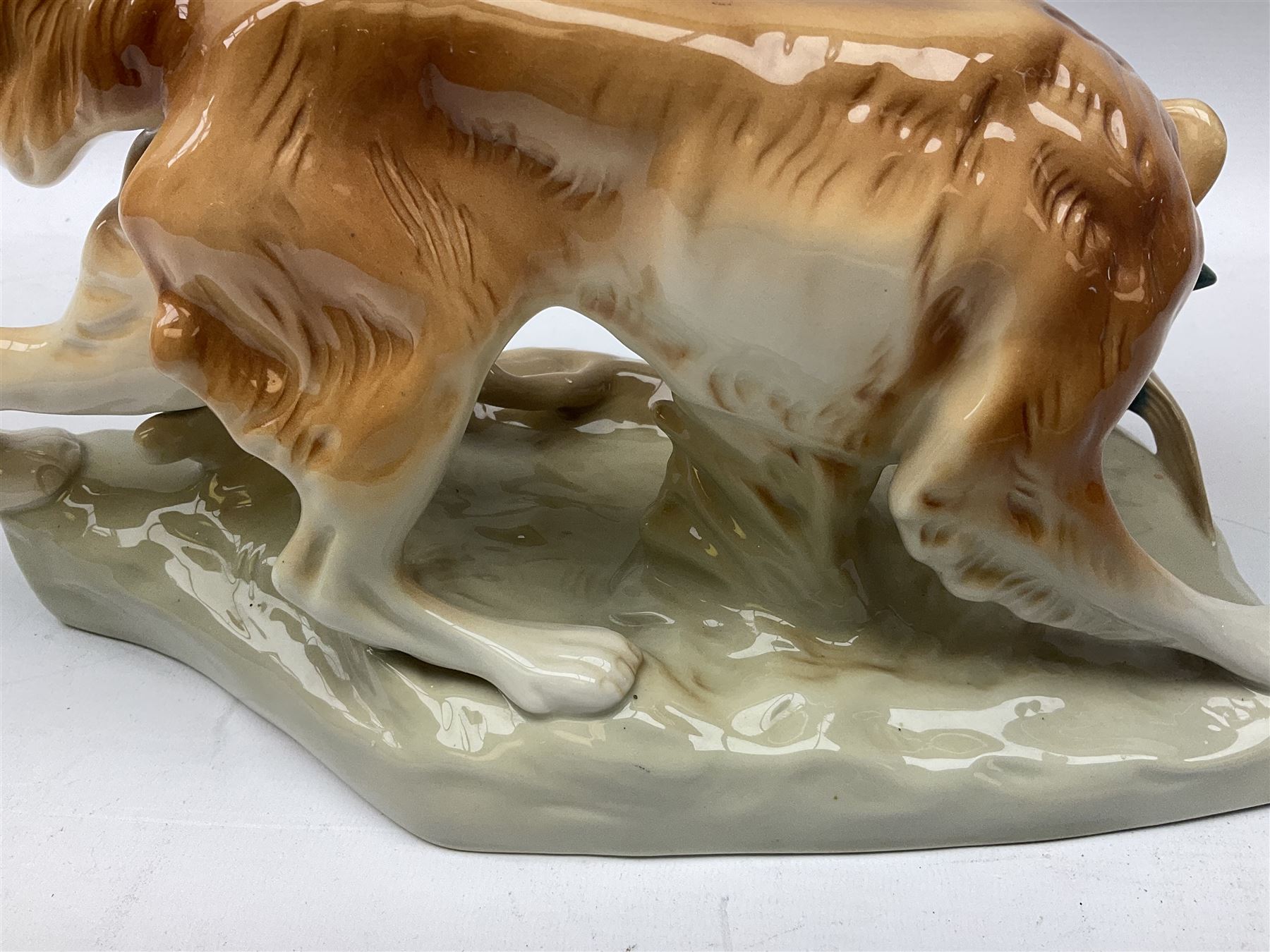 Royal Dux porcelain hunting dog with a bird, printed mark beneath, L36cm