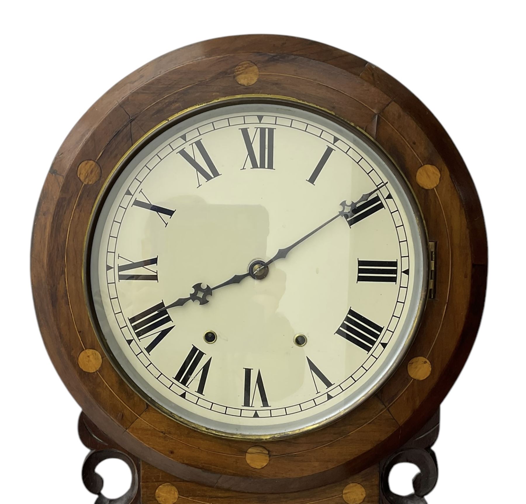 American- late 19th century 8-day mahogany drop dial wall clock, with a spun brass bezel and painted dial, Roman numerals, minute track and Maltese hands, case with an ogee base, satinwood inlay, carved case ears and a pendulum viewing door, twin train going barrel movement striking the hours on a bell. With pendulum. 