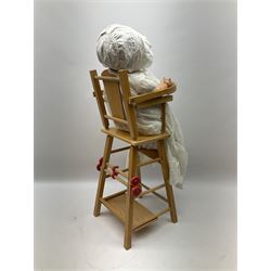 Armand Marseille composition head doll with moulded hair, sleeping eyes, open mouth with teeth and composition body with jointed limbs, marked 'AM Germany' H55cm; together with doll's beech high-cum-low chair with abacus (2)