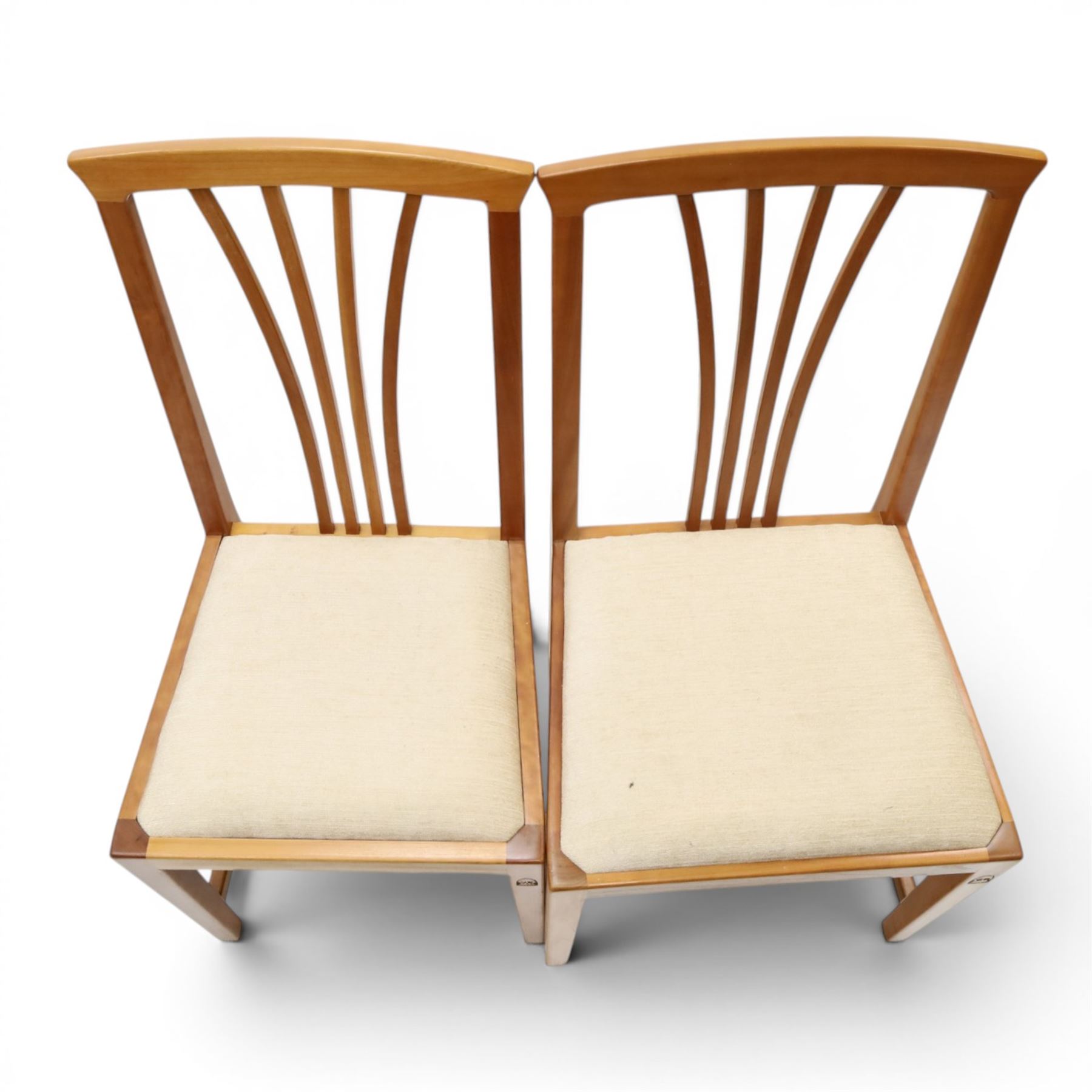 Knightman - set of nine cherrywood dining chairs, with fan splat backs and upholstered seats, raised on square legs joined by stretchers, comprising chairs of slight differing widths and one chair with turned front legs and orange upholstery and no Knight carving, the rest with recessed carved knight trademark, by Horace Knight of Old Mill Furniture, Balk near Thirsk 
