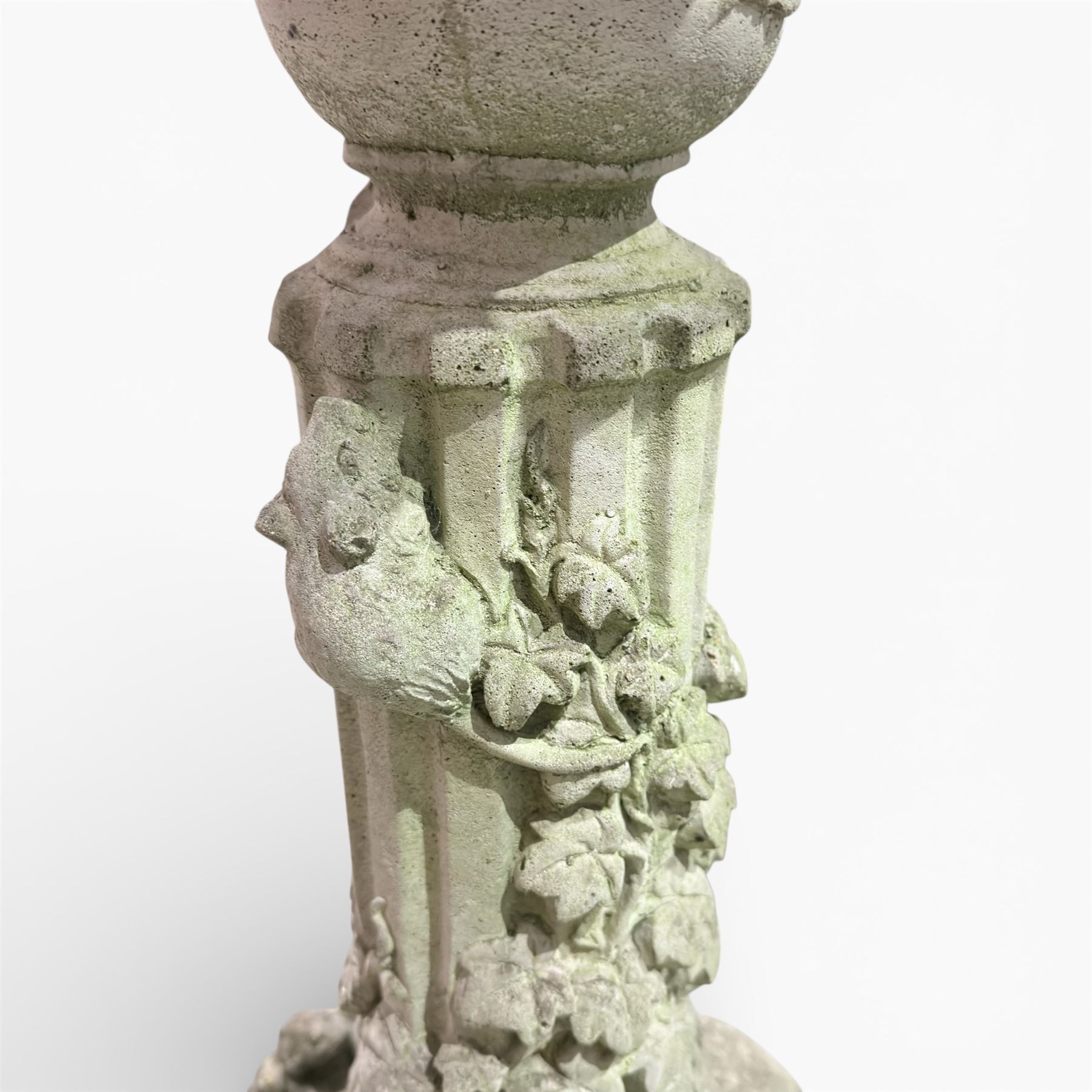 Cast stone bird bath on pedestal with cast iron water pump