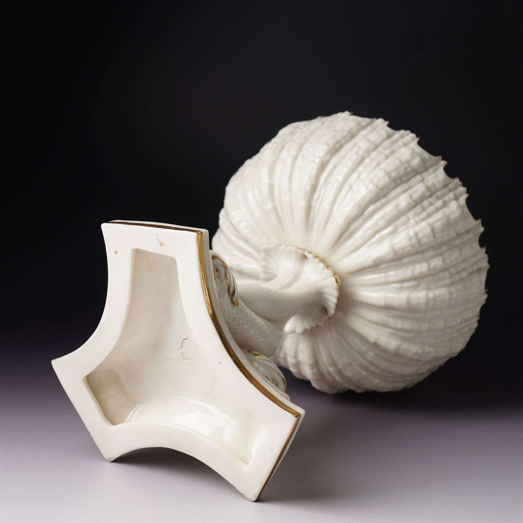 19th century Royal Worcester comport, painted with gilt on a cream ground, the stem formed as three entwined dolphins raising the shell shaped bowl, faint mark to base, H19.5cm