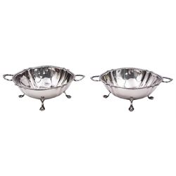 Pair of small 1920's silver footed bowls, each of shaped circular form with husk rim and twin handles, upon four paw feet, hallmarked Ellis & Co, Birmingham 1922, H.5cm D9.5cm, approximate weight 4.10 ozt (127.4 grams)