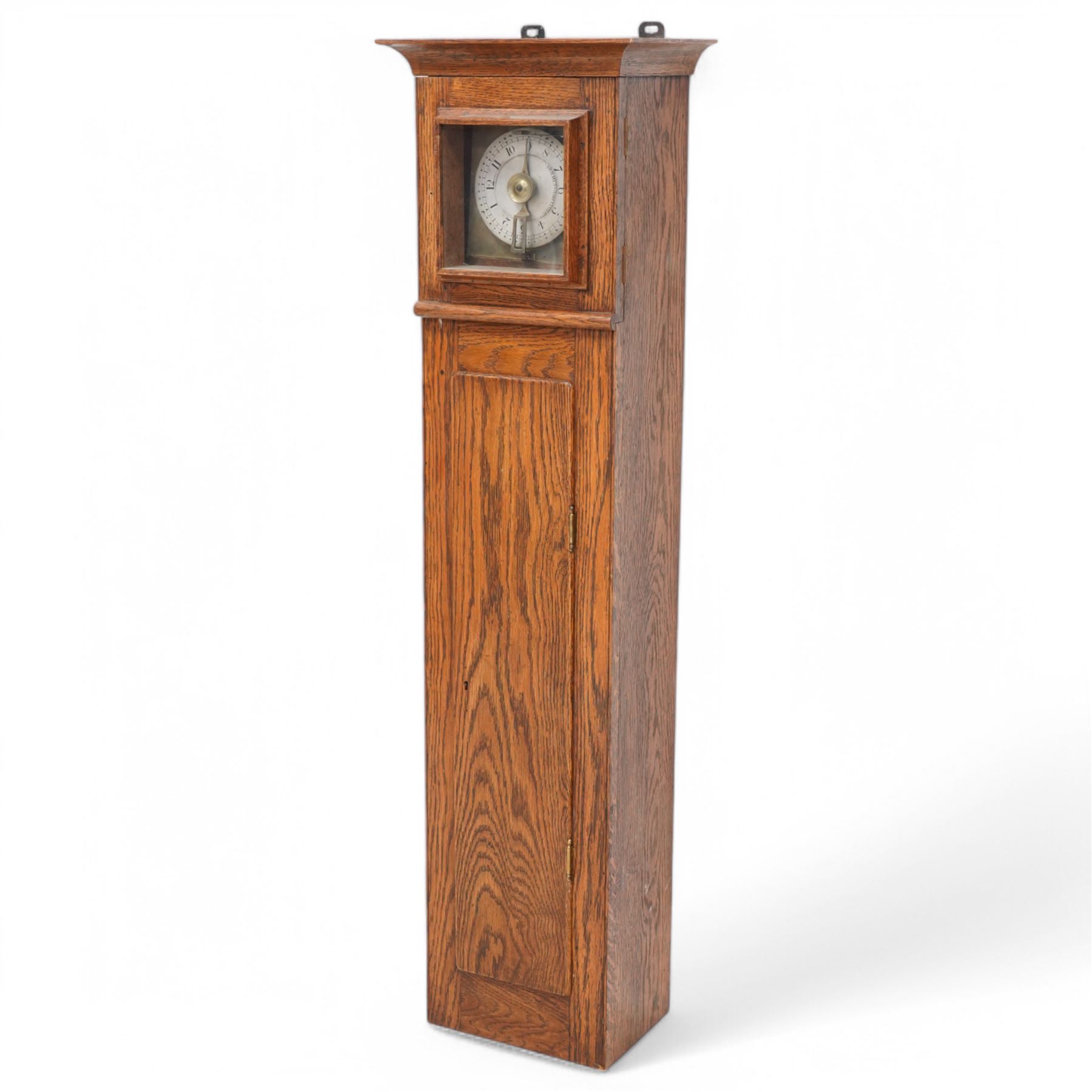 John Whitehurst of Derby- late 19th century oak cased wall hanging Noctuary or night watchman's wall clock, in a rectangular case with a moulded and glazed door to the dial and full length trunk door, with a silvered circular dial and a brass indicating pointer, Arabic numerals and quarter hour track with steel time recording pins, four wheel chain driven going train. No pendulum,chain or weight.    
John Whitehurst is one of the most prolific makers of these distinctive early type of night watchman's clocks, used predominantly in industrial premises, factories and mills in the north west of England during the 19th century.