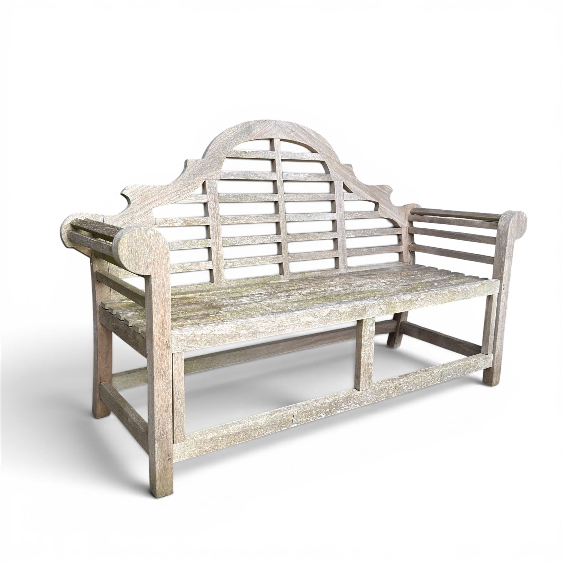 Lutyens design teak garden bench, shaped arched and slatted back over rolled arms and slatted seat, raised on square supports with box-stretcher