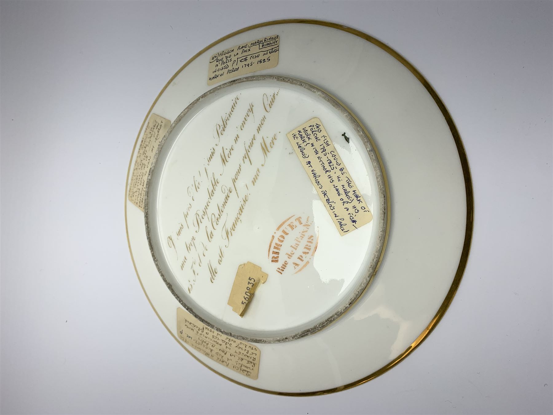 19th century Rihouet Paris porcelain cabinet plate, decorated with a central panel illustrating three French soldiers around a bottle laden table, one surveying a note, within a dark blue gilt detailed border, with French inscription verso, and red printed mark Rihouet Rue de la Paix A Paris and green fish mark, possibly for Perche, D23cm 



