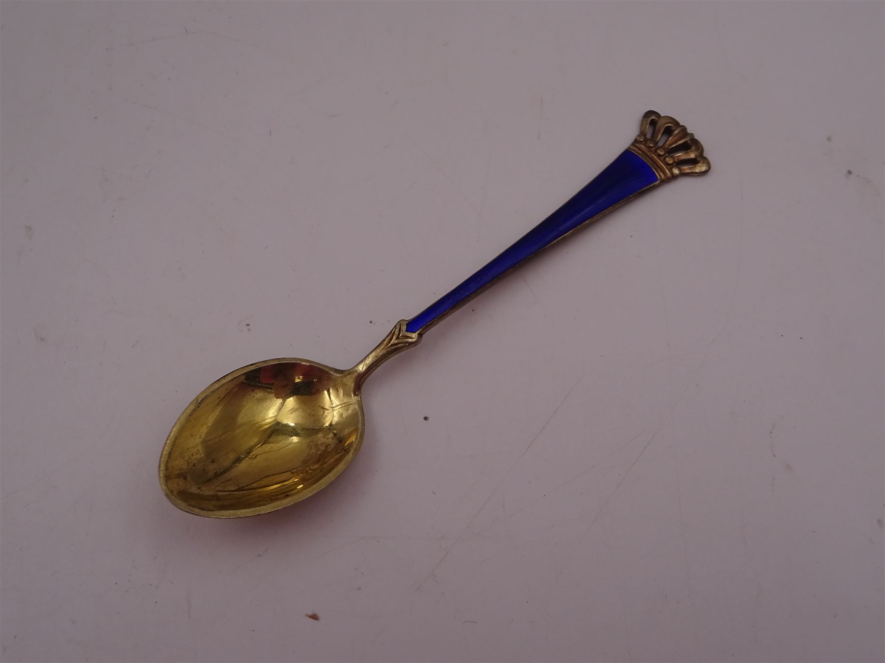 Set of six Danish silver-gilt blue enamel demitasse spoons with crown finials and together with an individually boxed example, all by Egon Lauridsen, stamped ELA Denmark Sterling 925S, both in fitted cases