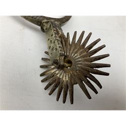 Pair of late 19th century South American iron spurs, engraved silver mounts, with sunburst rowls