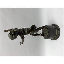 After E Plat, bronze modelled as a dancing child, signed E. Plat, upon cylindrical black marble base, H40cm