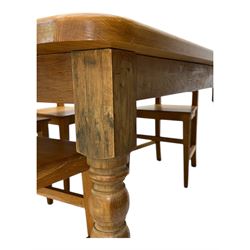 Contemporary light oak farmhouse dining table, and four oak ladder back dining chairs, rectangular top with rounded corners, raised on four turned baluster legs in natural lacquered finish, chairs with three horizontal slats beneath a shaped top rail, solid seat and square section legs united by stretchers