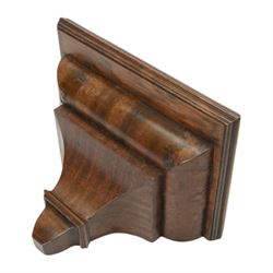 Early 20th century - mahogany cased 8-day miniature longcase clock with a matching wall mounted bracket,  break arch hood with ball finials and recessed quarter pilasters, conforming trunk with a long door and break arch top on a decorative plinth with a raised panel and stepped base, circular dial with Roman numerals and spade hands within a glazed bezel, French insert timepiece movement with a cylinder platform escapement, wound and set from the rear. With key.