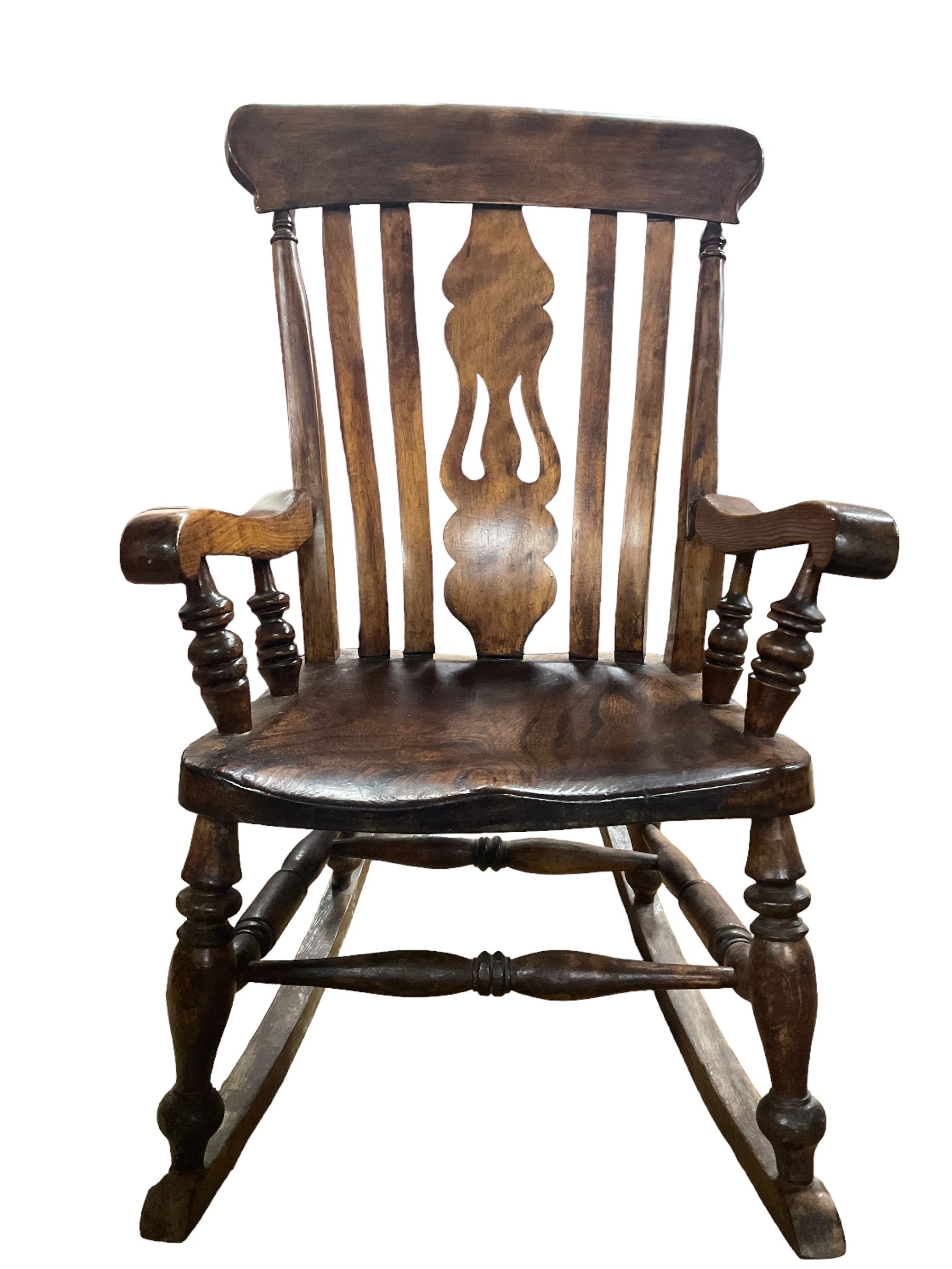 Late 19th century elm and beech farmhouse rocking chair, pierced splat and lath high back over saddle seat with turned supports