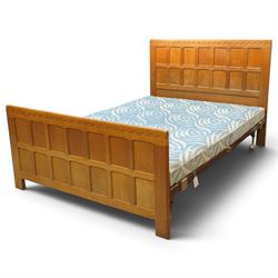 Mouseman - 4'6 panelled oak double bedstead, the head and footboard panelled with arcade c...