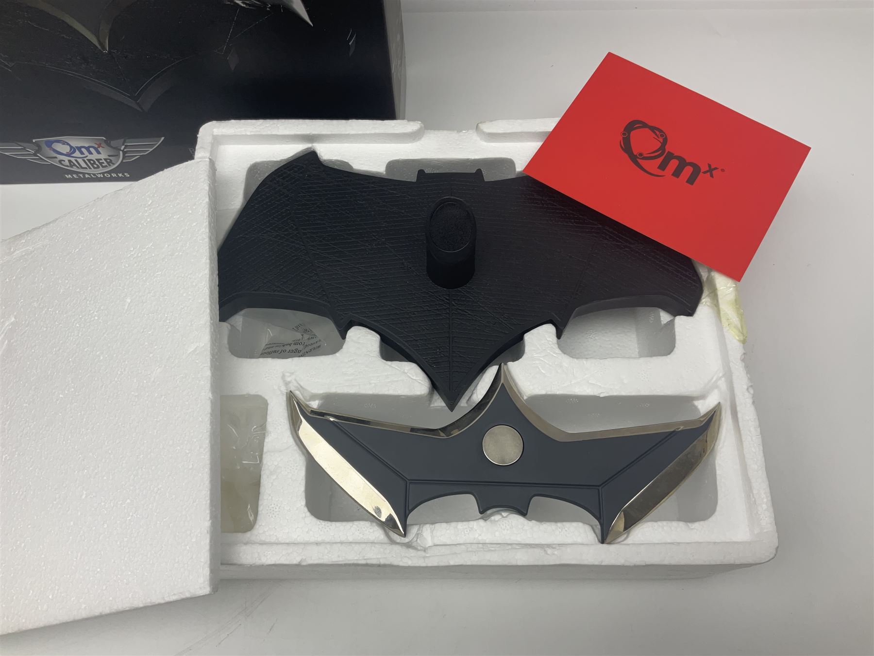 Two Batman replica Batarangs comprising DC Comics QMX Caliber Metalworks 1:1 scale replica with original box, and DC Direct The Dark Knight prop replica no. 33/1500 with original box and certificate of authenticity 