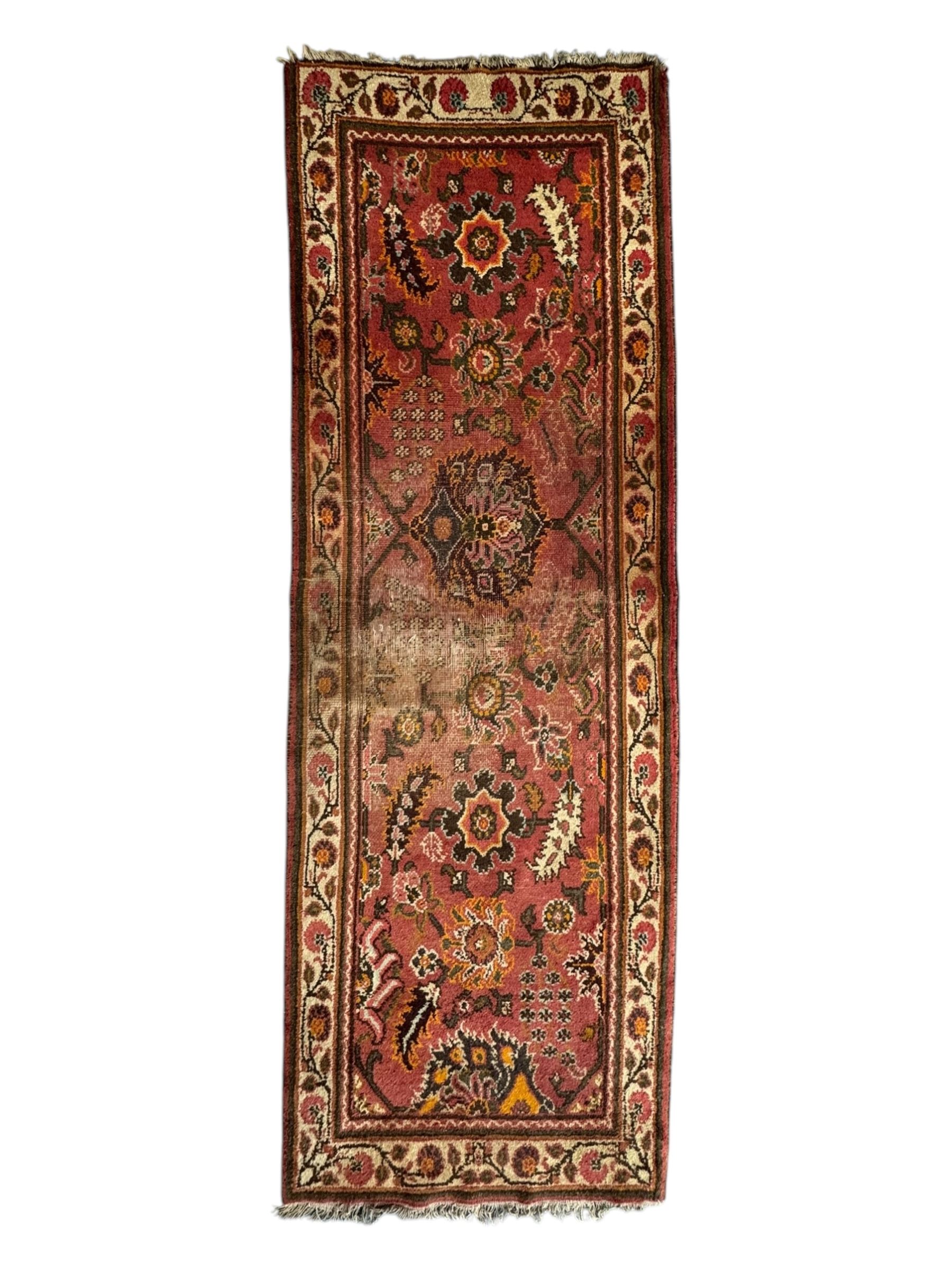 Belgian Sultan woollen ground rug, central navy field densely decorated with floral sprays and geometric patterns (192cm x 135cm); handwoven tribal terracotta ground rug (121cm x 71cm); Persian crimson ground runner, all over stylised floral and foliate motifs (266cm x 94cm)