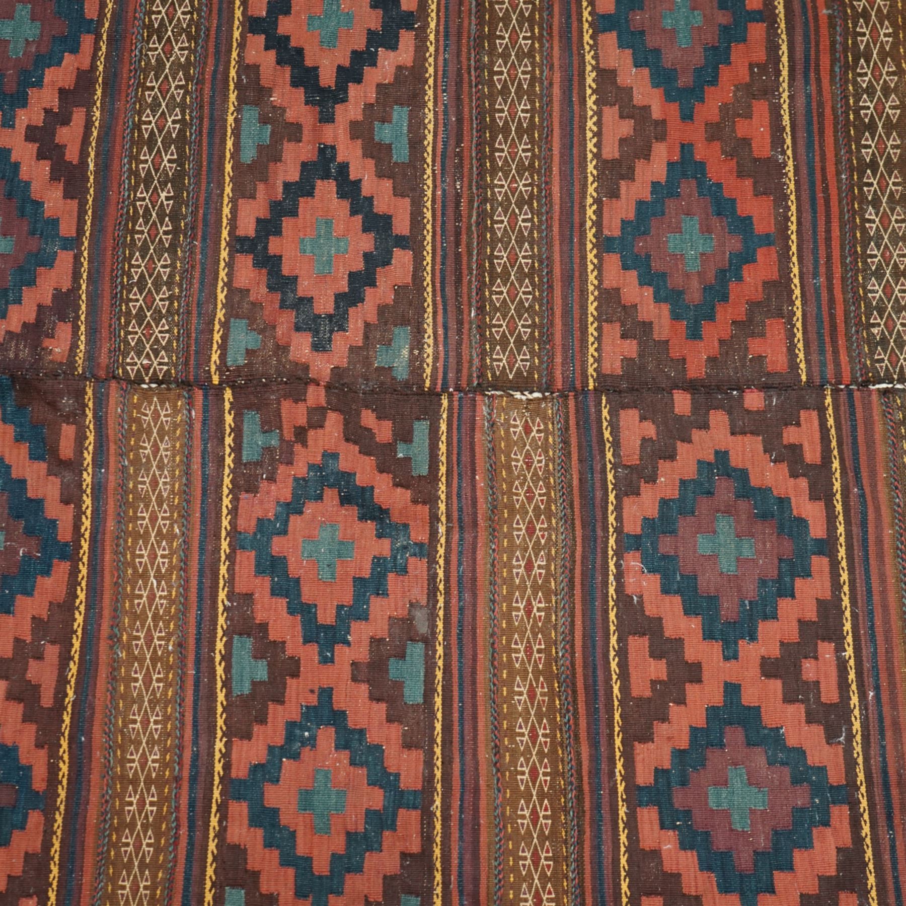 Group of four late 20th century wool kilim rugs, comprising a narrow tribal runner with stylised tree motifs and hooked guard bands (H 180cm, W 56cm), a lozenge medallion rug with decorative striped ends (H 125cm, W 75cm), a red and blue kilim with trefoil repeat field and multicoloured border bands (H 187cm, W 98cm), and a wide horizontal striped example with alternating lozenge and linear motif rows (H 260cm, W 173cm)