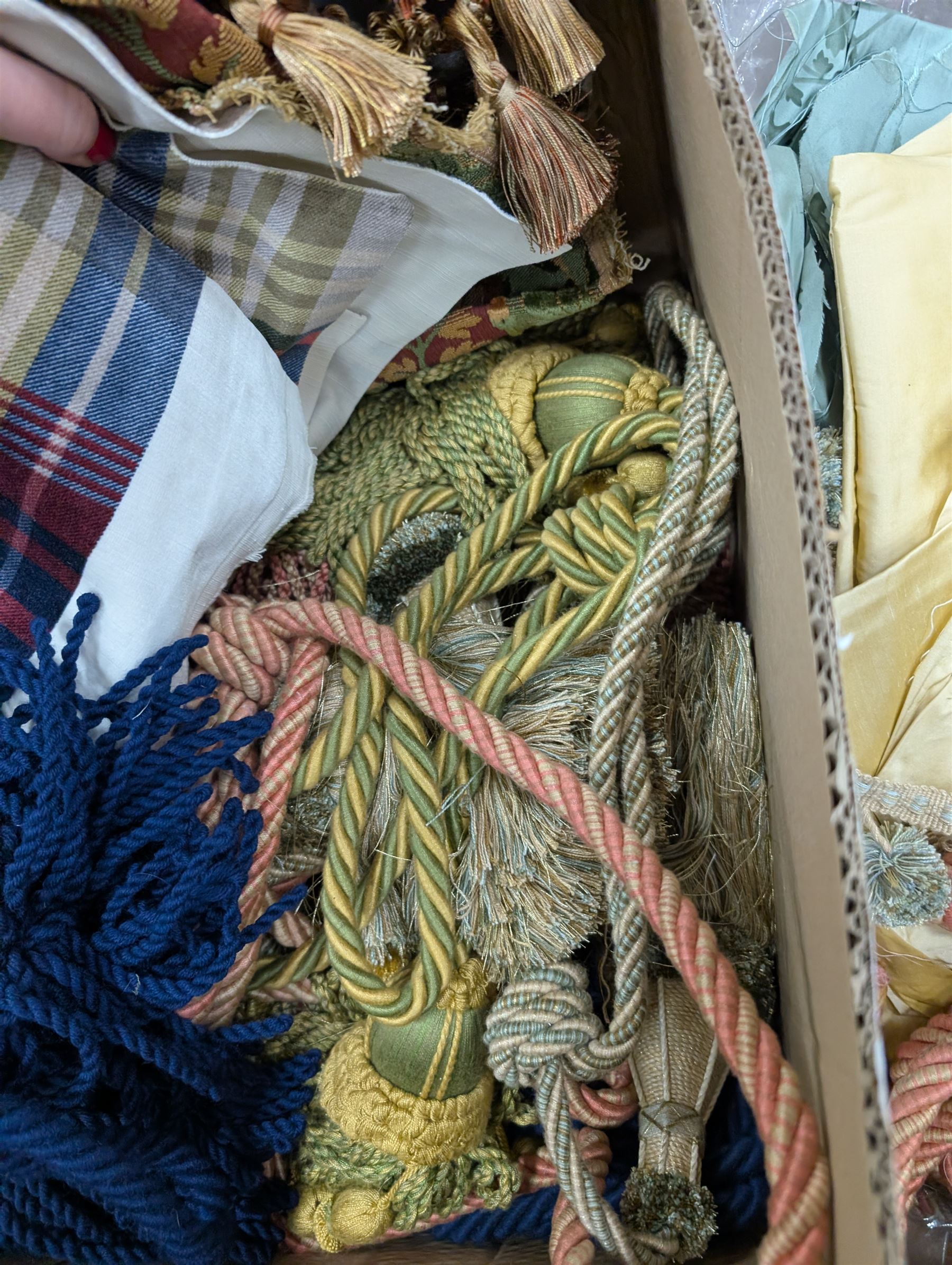 Collection of curtain fabric pieces and tassels