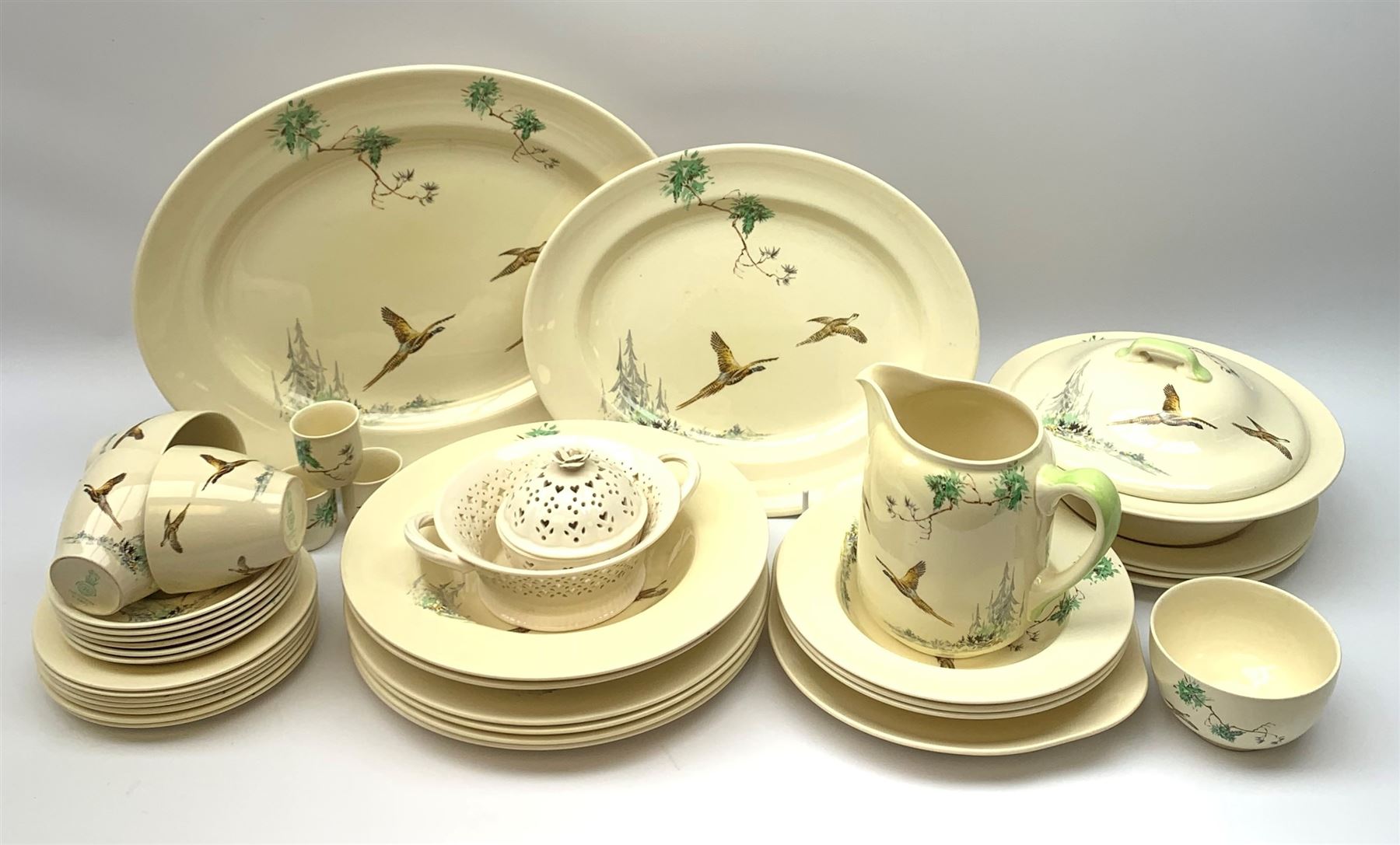 Royal Doulton The Coppice pattern dinner wares, comprising four dinner plates, three salad plates, two large bowls, three smaller, seven side plates, tureen and cover, two oval serving platters, sandwich plate, jug, three tea cups and six saucers, open sucrier, and three egg cups, together with two pieces of  Hartley Greens & Co, Leeds Pottery. 
