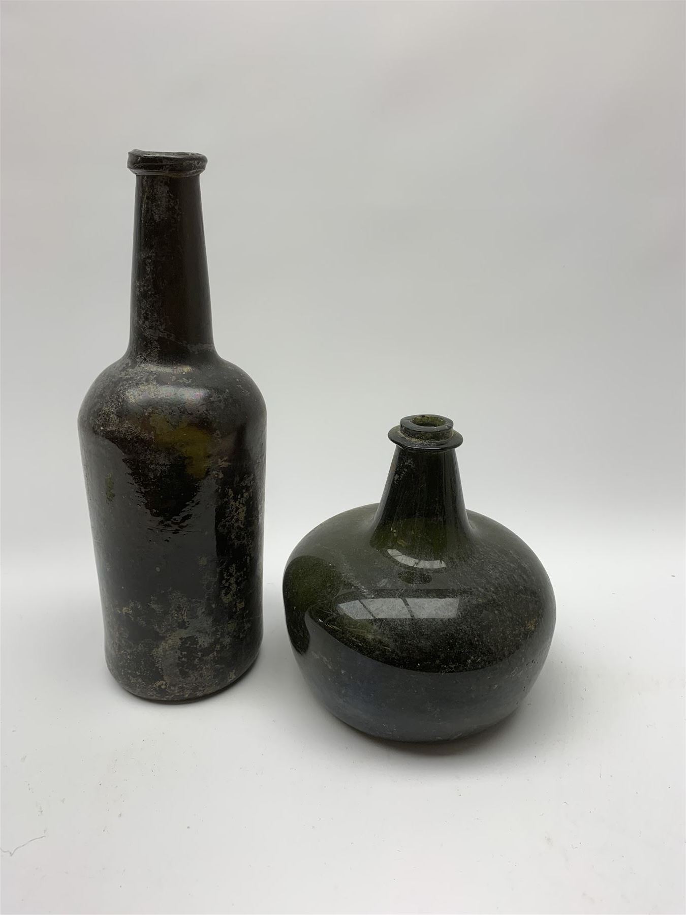 18th century green glass bottle, of onion form, H15cm, together with an 18th century green glass wine bottle, with seal depicting a boar beneath a crown, probably the Edgcumbe Crest, H27cm