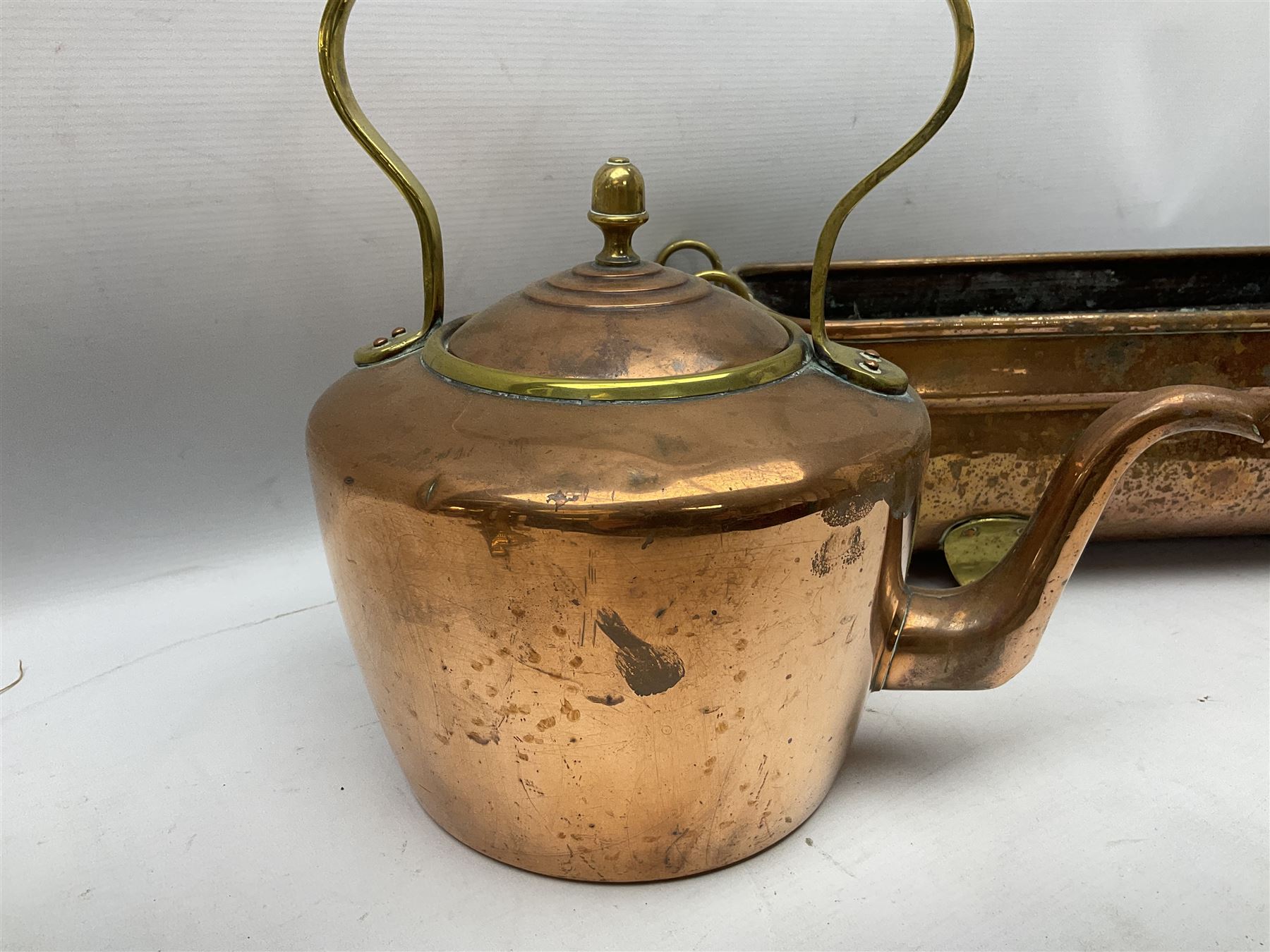 Copper planter of rectangular form with brass feet and twin handles, together with a brass mounted copper kettle, longest L54cm