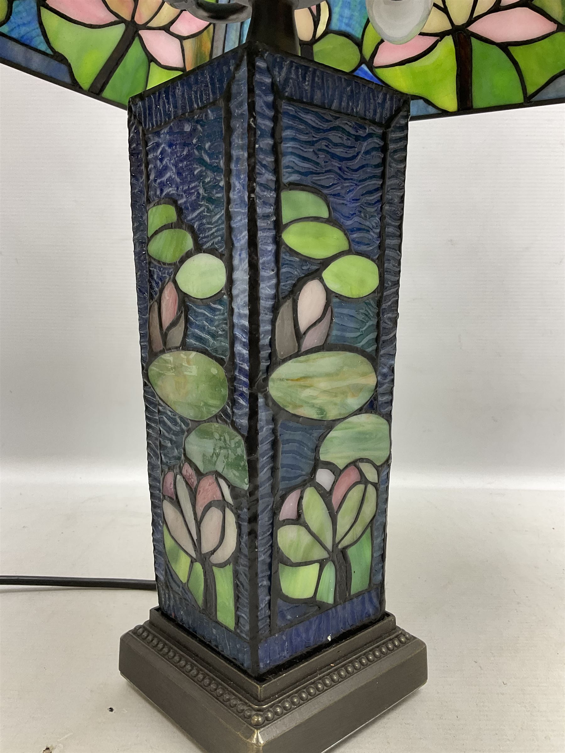 Tiffany Pond Lily style table lamp and shade with leaded panels of green, pink and rippled blue water effect ground, raised upon brushed metal base, H50cm