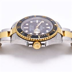 Rolex Oyster Perpetual Submariner Date gentleman's stainless steel and gold automatic wristwatch, Ref. 116613LN, serial No. 8201P7C5, back dial with luminous hour markers, unidirectional rotating black ceramic bezel, on stainless steel and yellow gold Rolex Oyster bracelet with fold-over clasp, boxed with guarantee card dated 2013