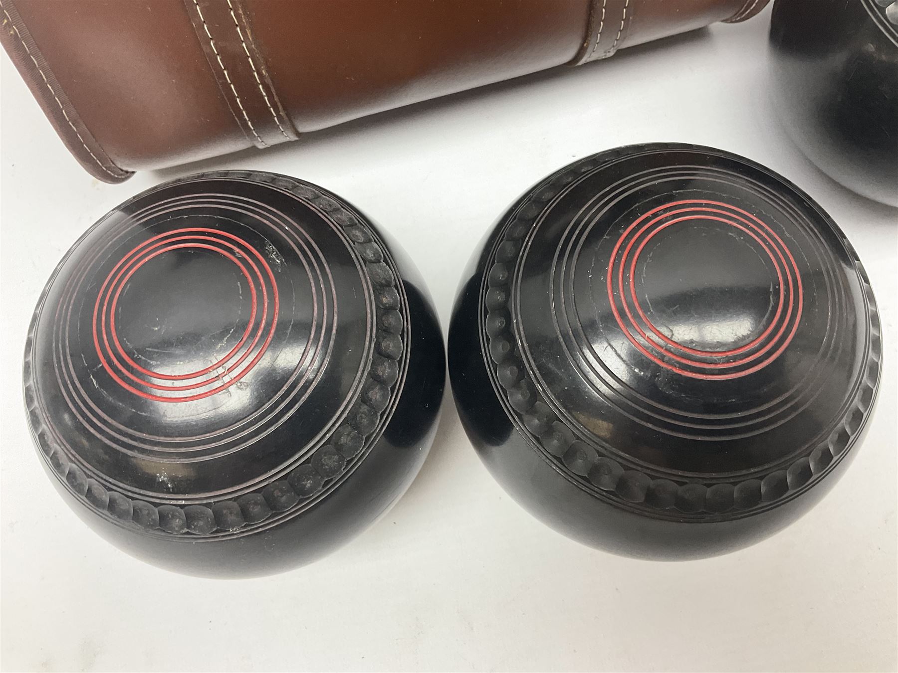 Eight Greenmaster lawn green bowling balls, comprising set of four size