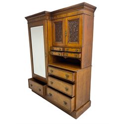 Victorian figured oak and pollard oak combination wardrobe, projecting dentil cornice, the left hand side enclosed by large bevelled mirror glazed door over drawer, the interior with sliding hanging rail, the right hand side with cupboard enclosed by two panelled doors relief carved with urn and trailed trailing foliage, four small drawers over shelf, three drawers and brushing slide, the slide with tooled and gilt blue leather inset, plinth base