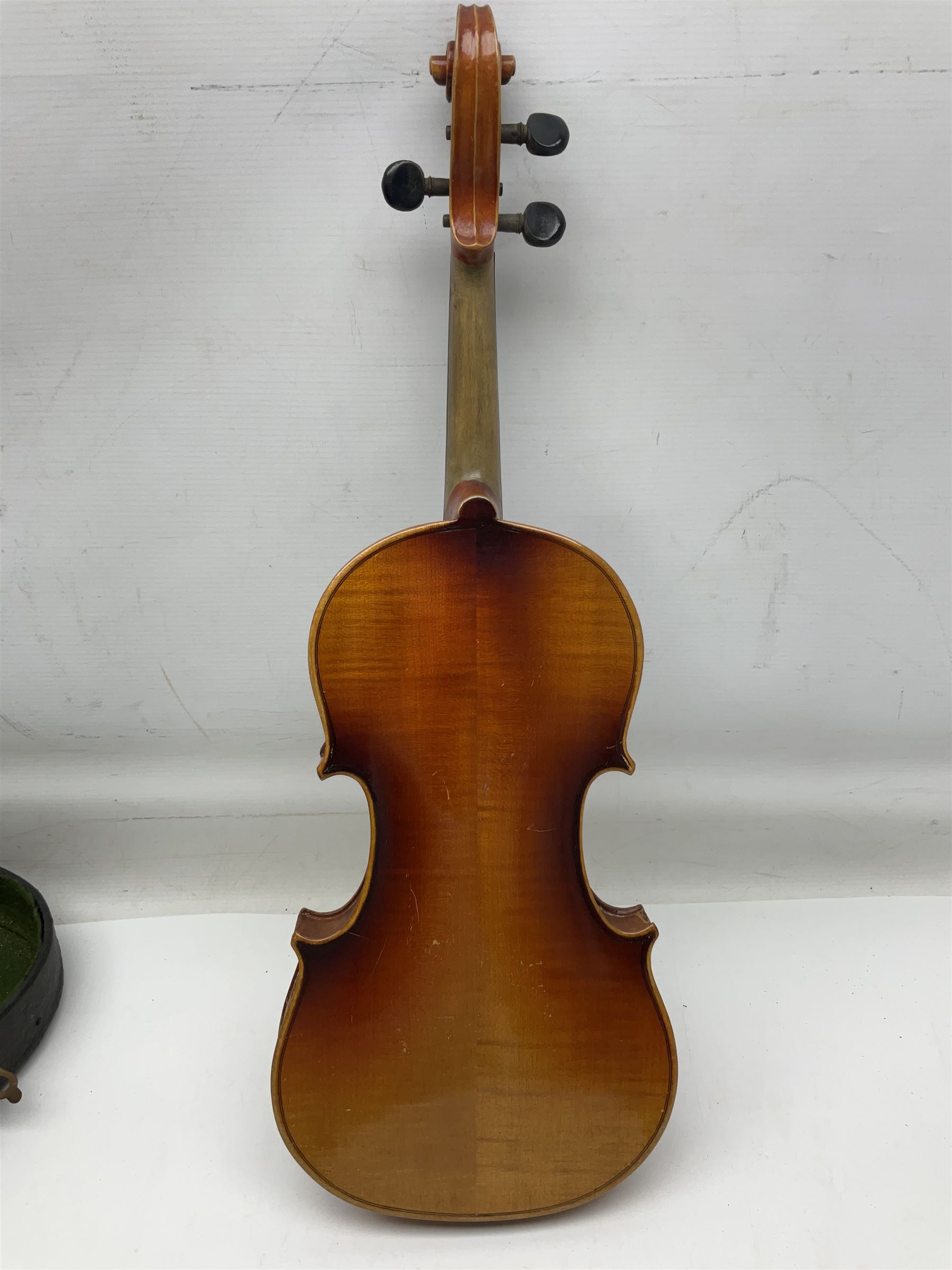 Czechoslovakian violin c1920 with 36cm two-piece maple back and ribs and spruce top, bears label 'Copy of Antonius Stradivarius Made in Czechoslovakia' L59cm; in carrying case; 1950s Czechoslovakian violin; and 195os Czechoslovakian three-quarter size violin; both cased (3)