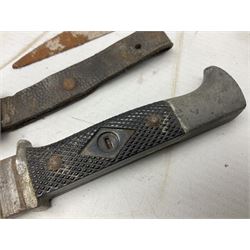 Indian kukri with 29cm curving steel blade and nickel mounted horn grip; in leather covered scabbard with one skinning knife L42cm overall; Hitler Youth knife with scabbard in relic condition; and three African graduated knives each with crudely carved wooden grips and painted leather covered scabbards (5)