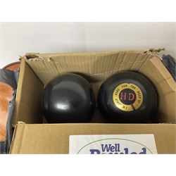Five sets of bowling balls, four with bags