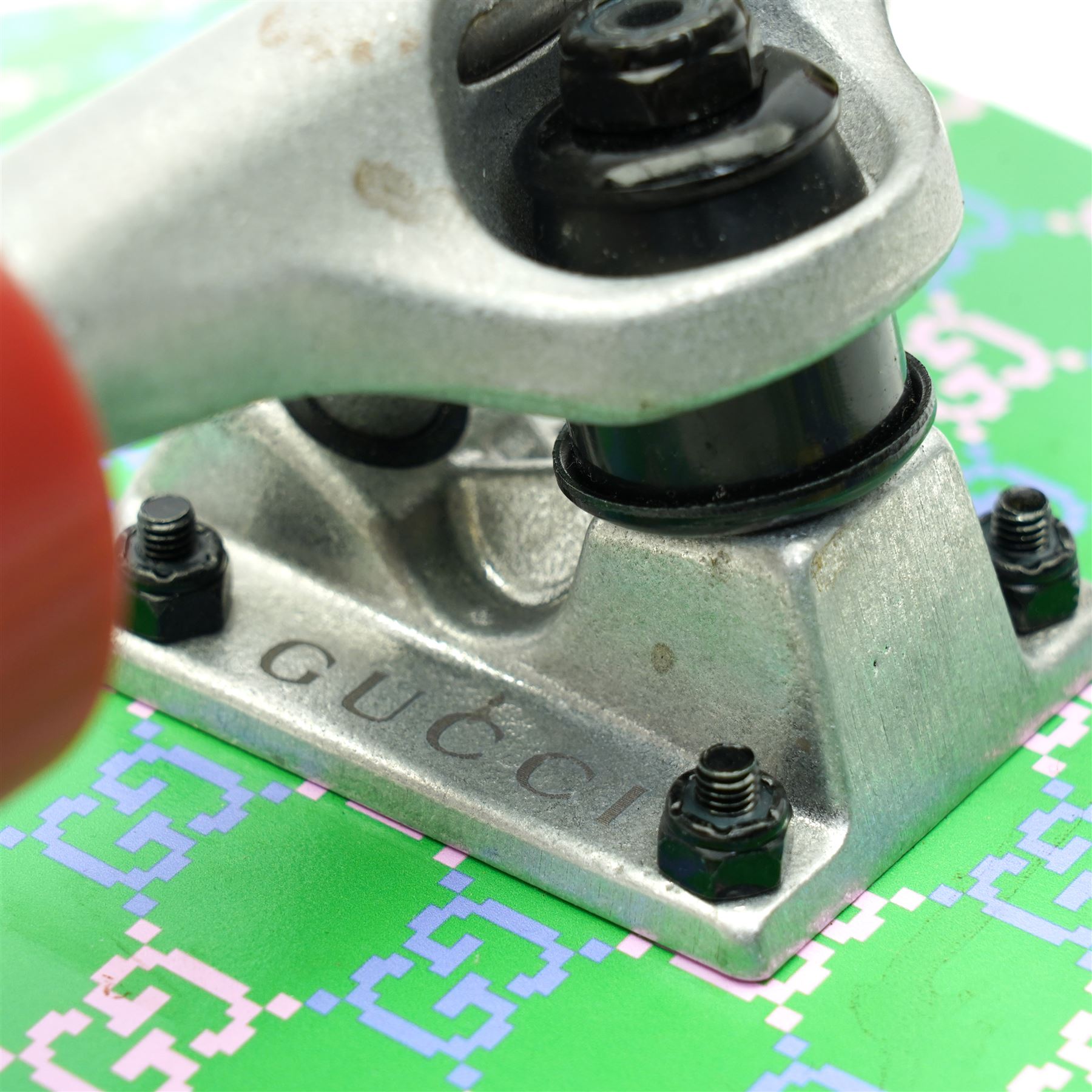 Gucci x Palace skateboard, Spring/Summer 2021, green GG monogram wood deck with multicolour ‘AH AH AH! GUCCI’ lettering and cartoon character mascot motif, fitted with Gucci-branded metal trucks and red and cream wheels, model no. 689103 JCGMN, presented with original GG monogram drawstring dust bag, protective sleeve, outer box and accompanying cards, Skateboard L81cm W20cm