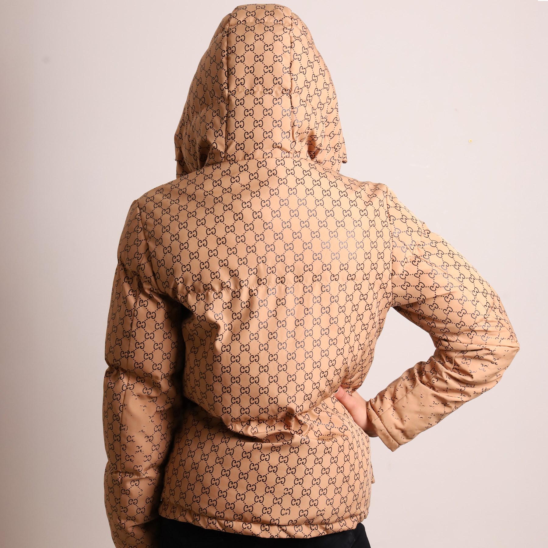 Gucci x The North Face – monogram hooded puffer jacket, beige and ebony GG monogram fabric with embroidered Gucci x The North Face logos to the chest and interior collar, detachable/adjustable hood, zip fastening with silver tone press-studs, flap pockets and vivid orange lining, size S
