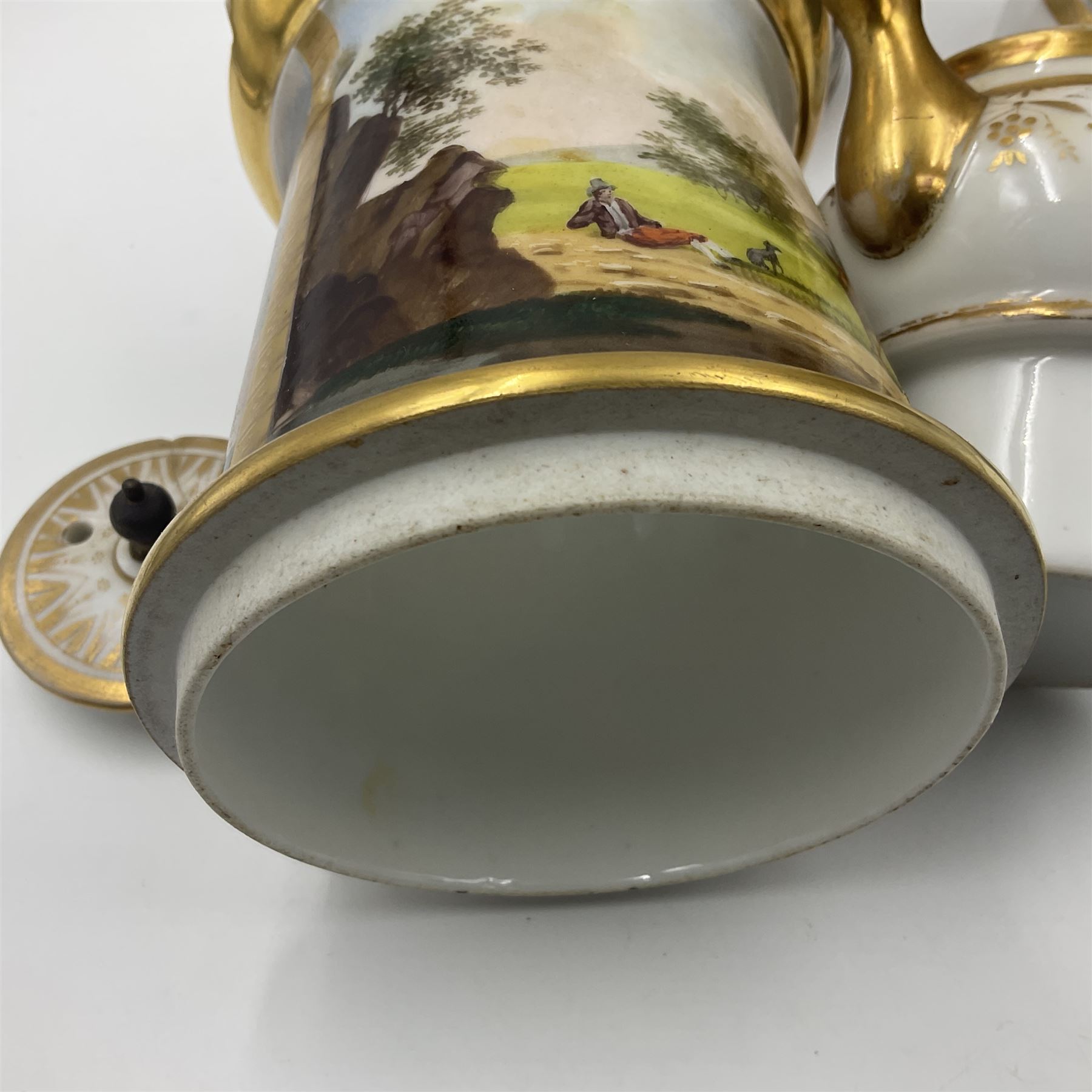 Two 19th century continental teapots and warmers, each teapot upon a cylindrical warming base, hand printed with seascapes, largest H22cm 