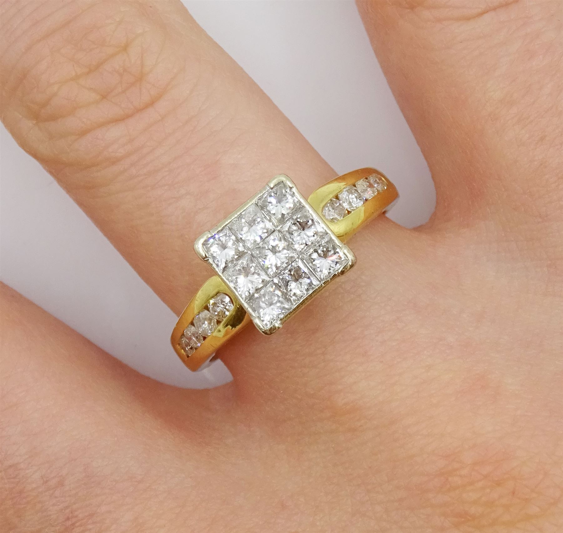 18ct princess cut diamond cluster ring, with round brilliant cut diamond shoulders, stamped 18KT, total diamond weight 1.00 carat