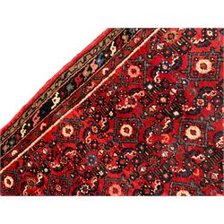 Persian crimson ground runner, the field decorated with Herati motifs,  three-band border, the main band decorated with repeating flowerheads 