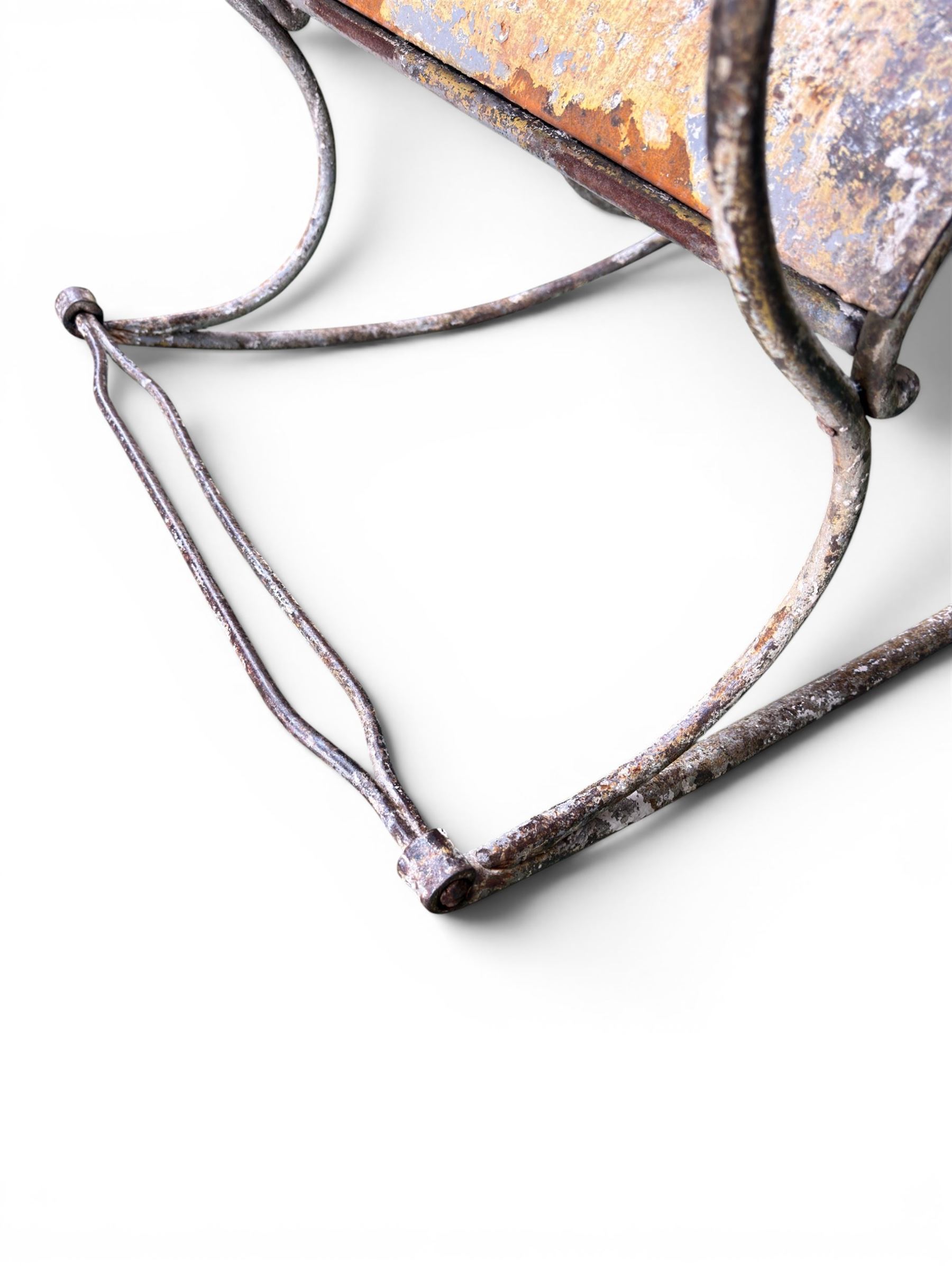 Pair of large unusual 19th century wrought iron garden rocking chairs, simple scroll design, lacking canvas seat