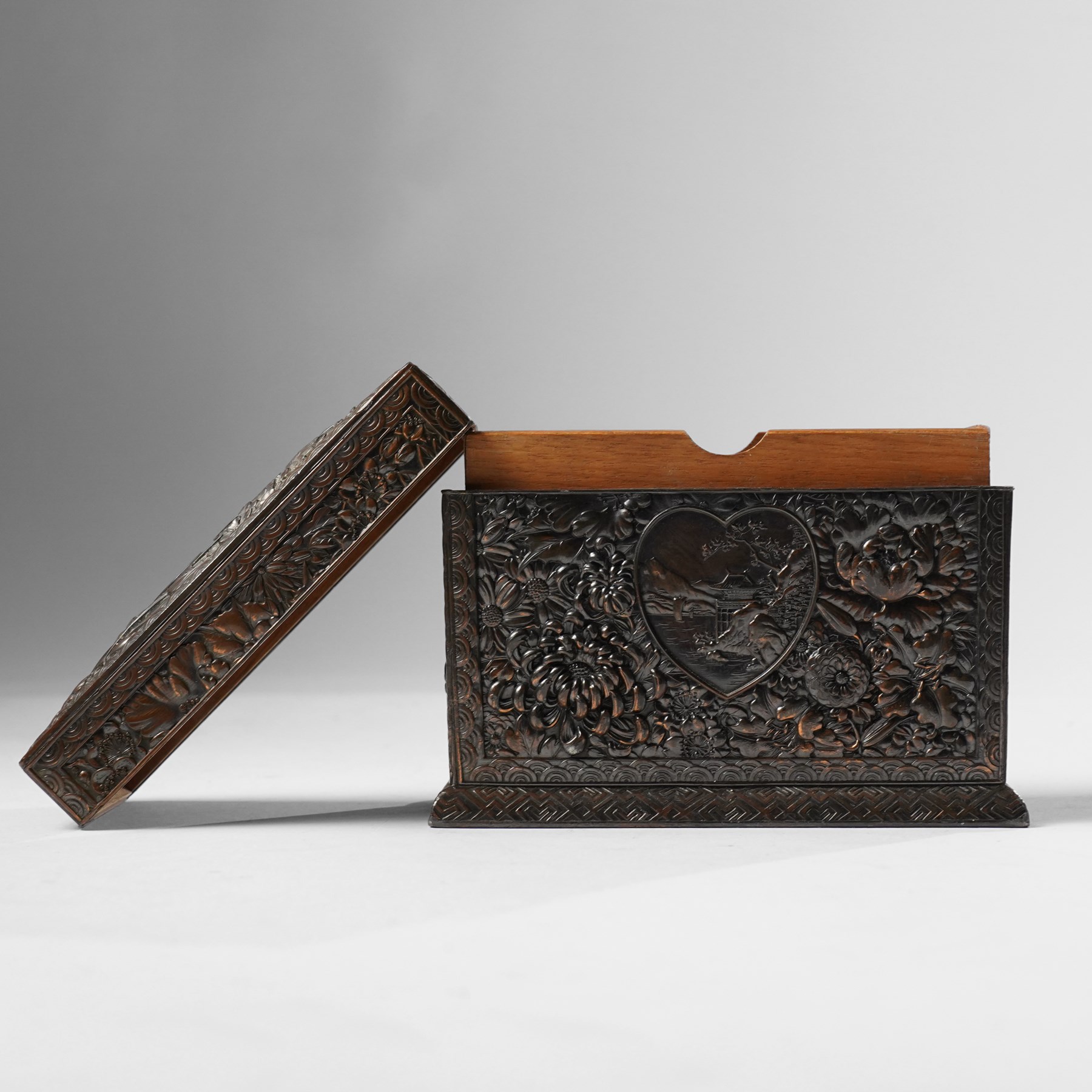 Japanese Meiji period bronze playing card box, decorated with intricate repoussé floral motifs, marked to base