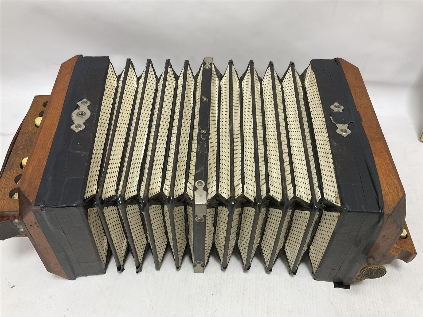Three European concertinas, comprising Viceroy German concertina with 21 keys, hexagon wooden frame and 8 fold bellows
Oak framed concertina with 12 keys and 8 fold bellows
Commander concertina with 12 keys and 12 fold bellows
With tutor
